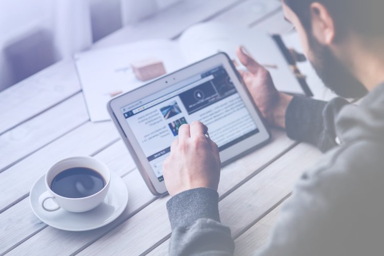 Mężczyzna przegląda na tablecie stronę internetową typu one page